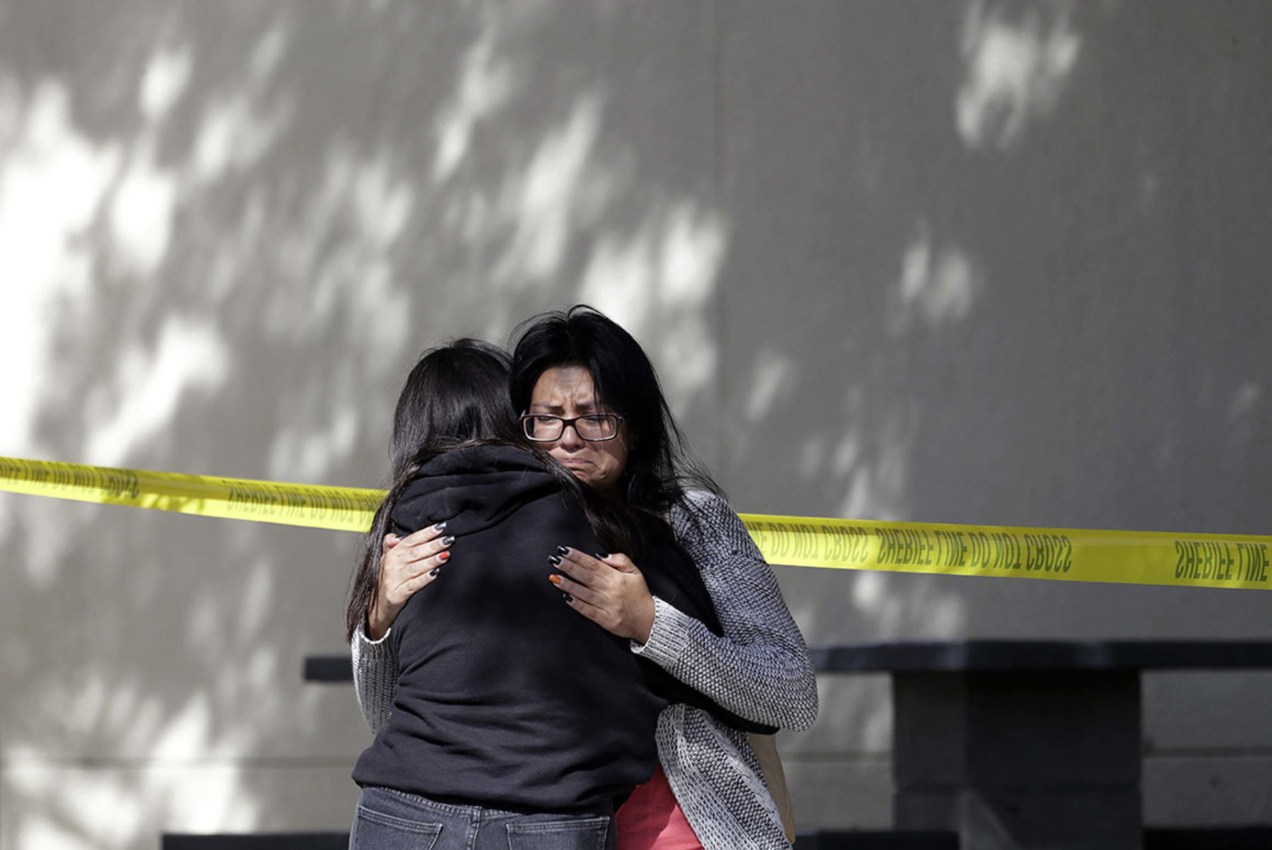 Mourners embrace