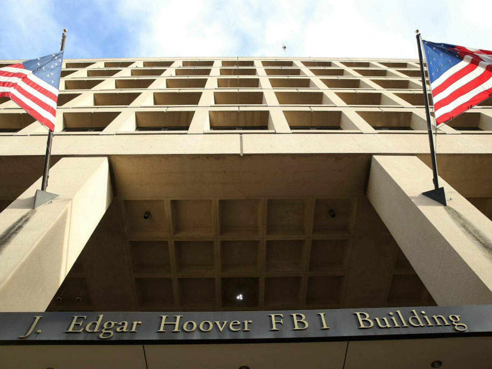 FBI building flanked by American flags.
