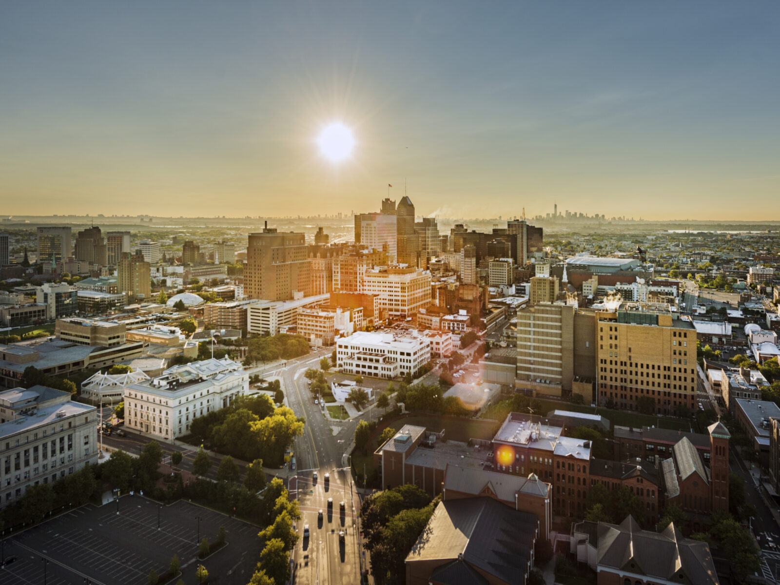 Skyline view of Newark with sun setting in back.