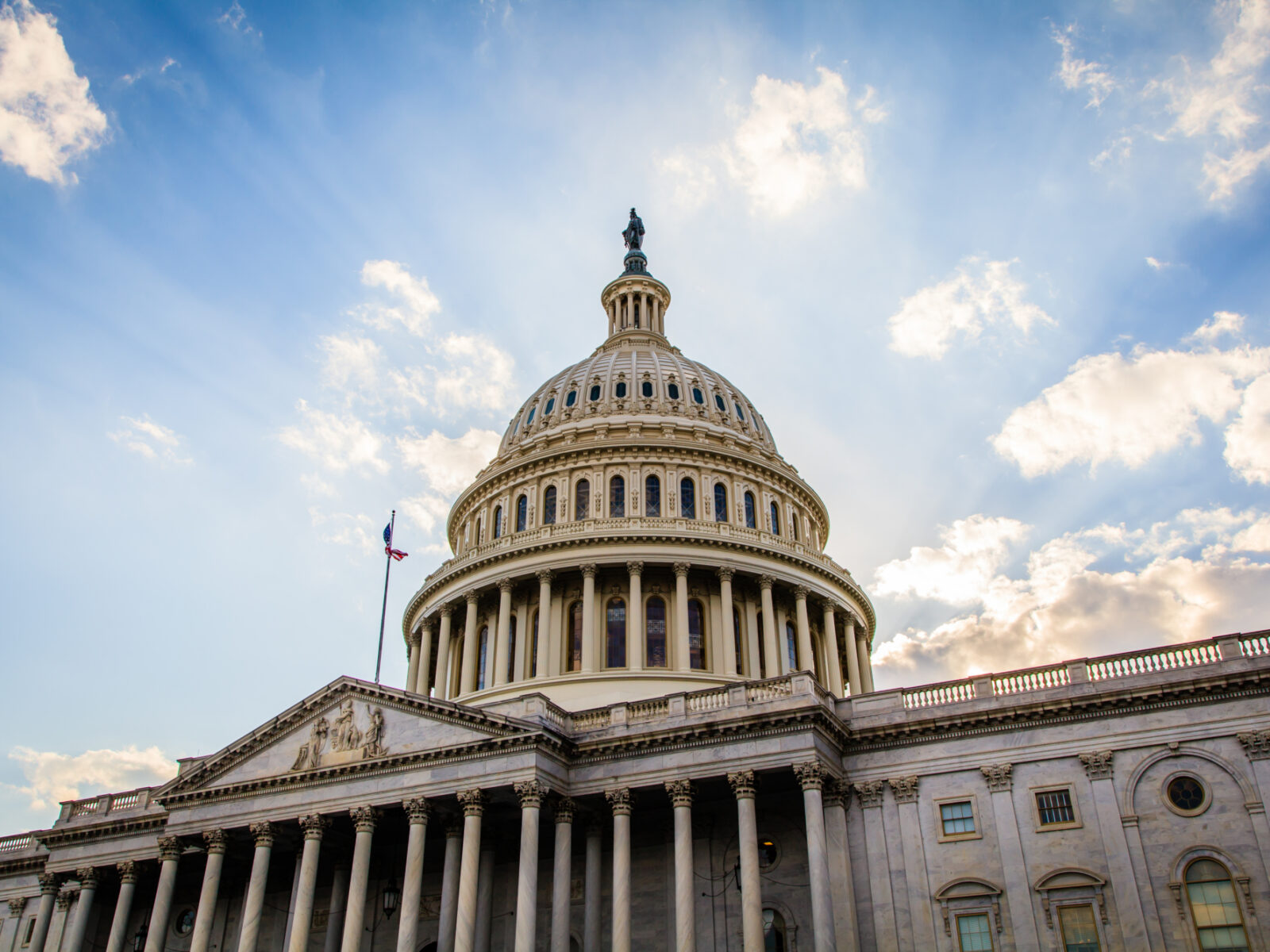 Angled image of u.s. congress building with blue sky in background.